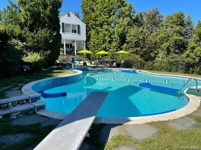View of pool featuring a diving board View of pool featuring a diving board