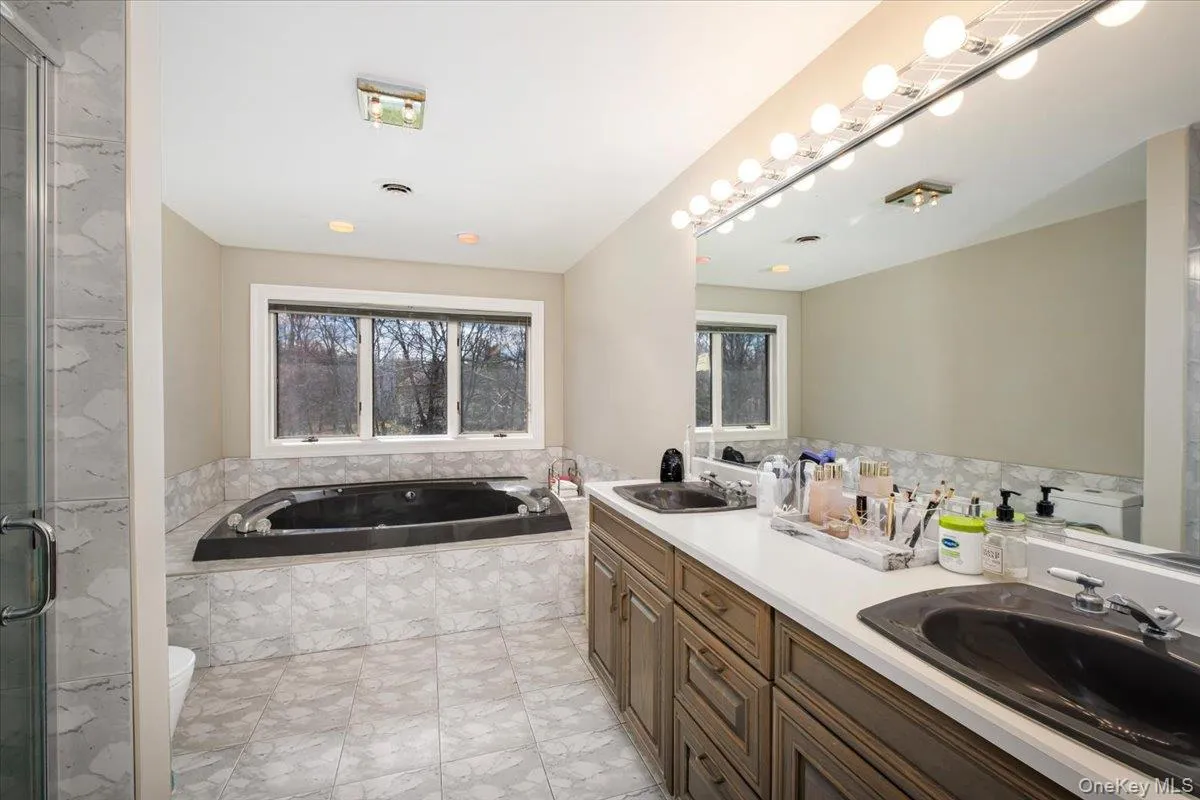 Upper level hallway full bathroom with tub and shower Upper level hallway full bathroom with tub and shower