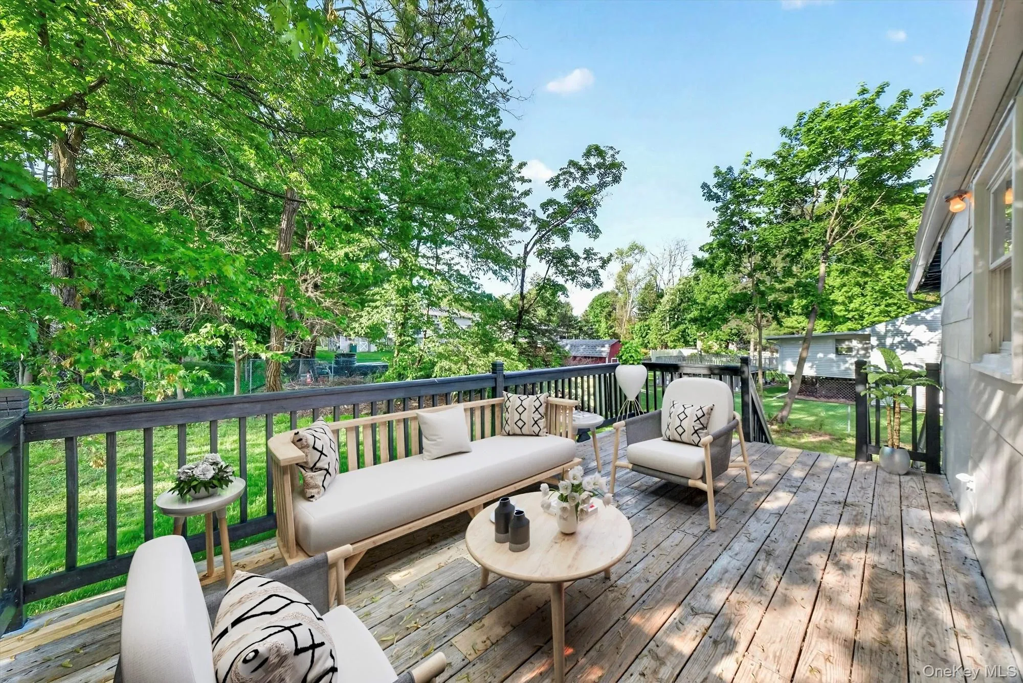 Virtually Staged. Step outside to the deck, a great space for morning coffee, outdoor dining, grilling, or simply relaxing while enjoying the backyard setting. Virtually Staged. Step outside to the deck, a great space for morning coffee, outdoor dining, grilling, or simply relaxing while enjoying the backyard setting.