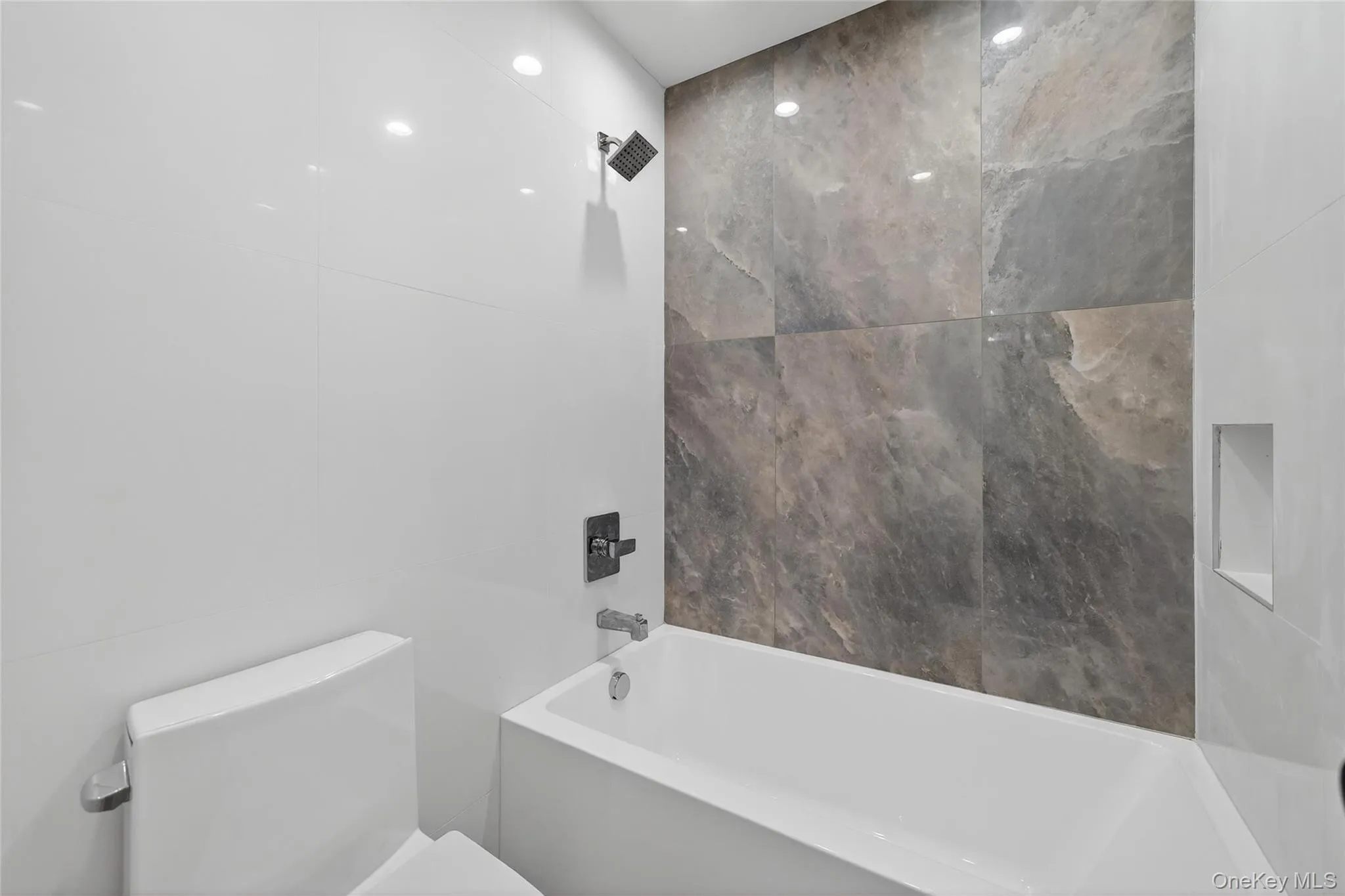 Bathroom featuring shower / bath combination and toilet Bathroom featuring shower / bath combination and toilet