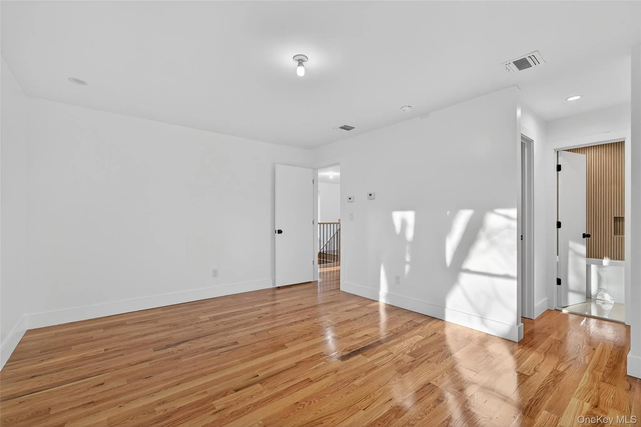 Empty room featuring light wood-style flooring and recessed lighting Empty room featuring light wood-style flooring and recessed lighting