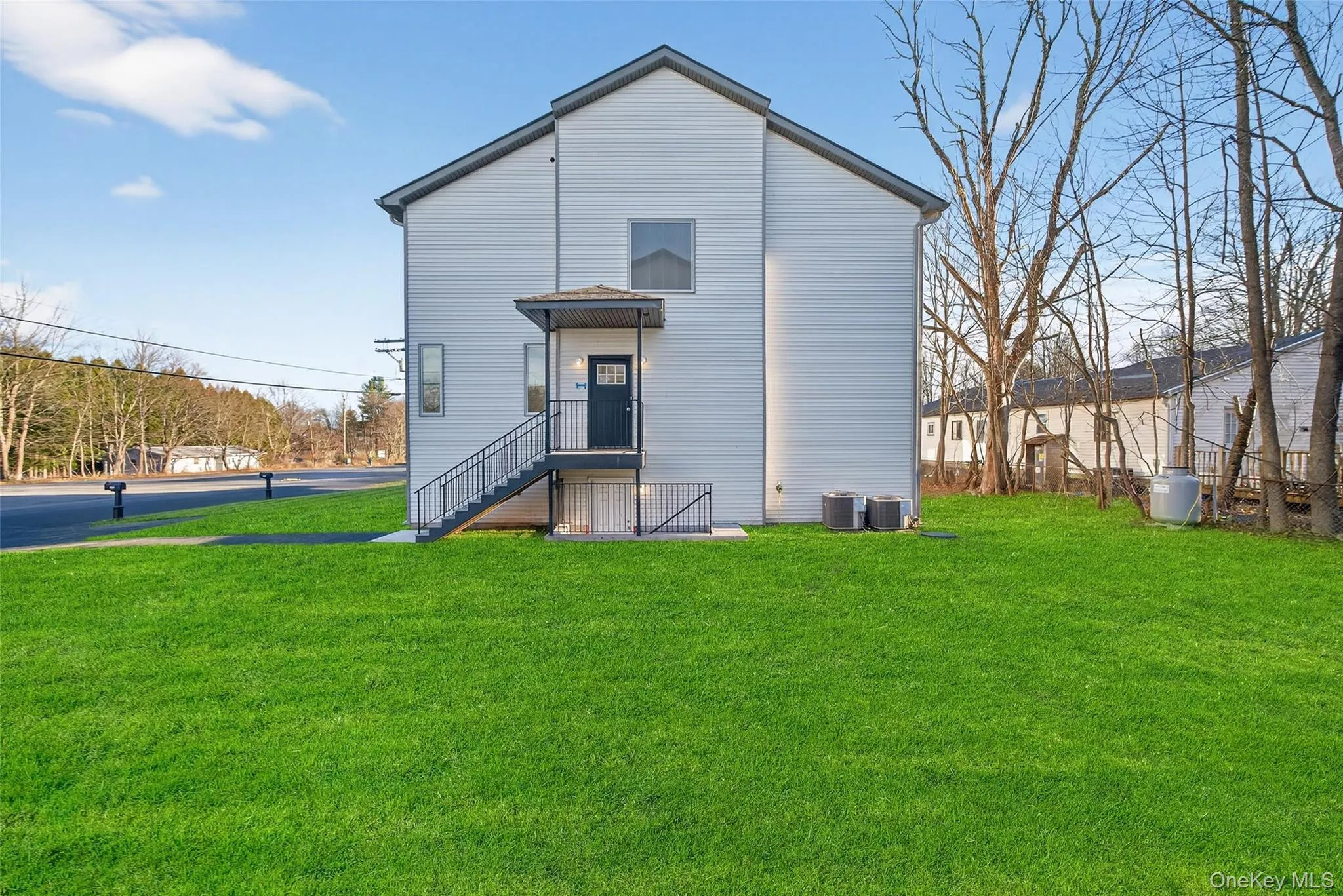 Rear view of property featuring a yard Rear view of property featuring a yard