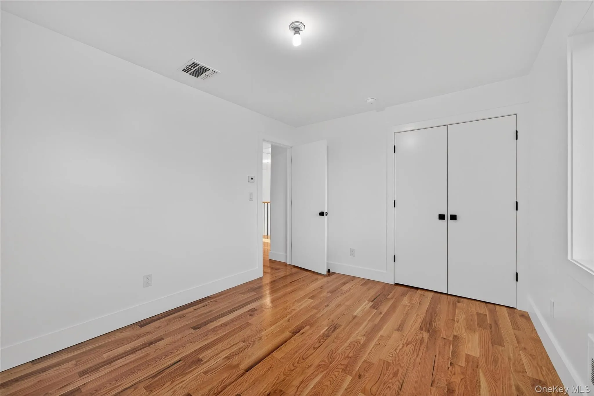 Unfurnished bedroom featuring light wood-type flooring and a closet Unfurnished bedroom featuring light wood-type flooring and a closet