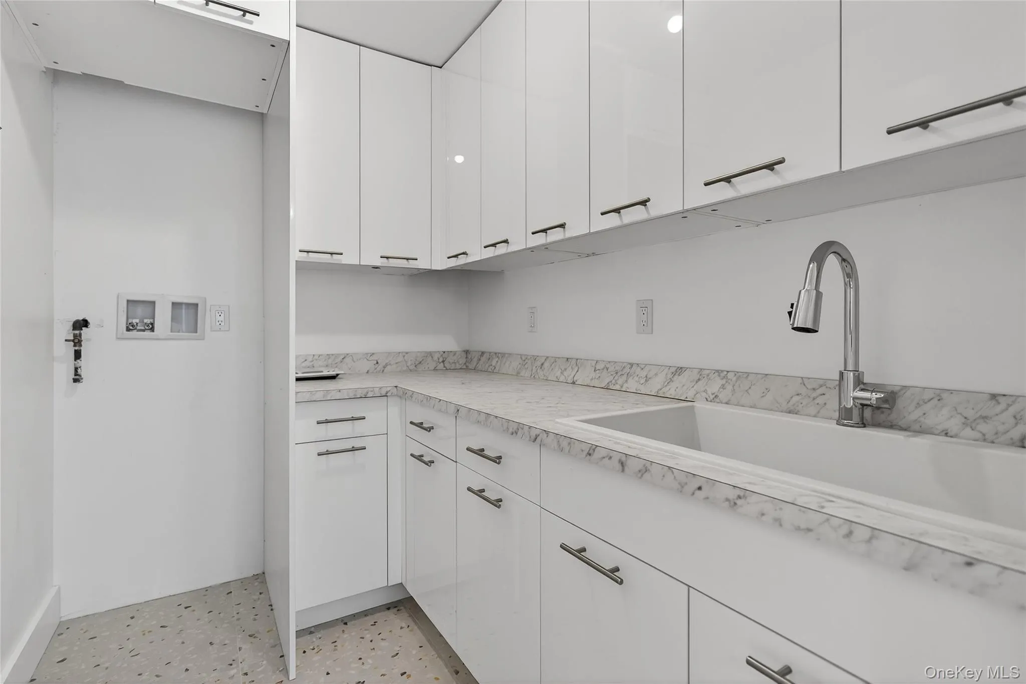 Laundry room featuring hookup for a washing machine and cabinet space Laundry room featuring hookup for a washing machine and cabinet space