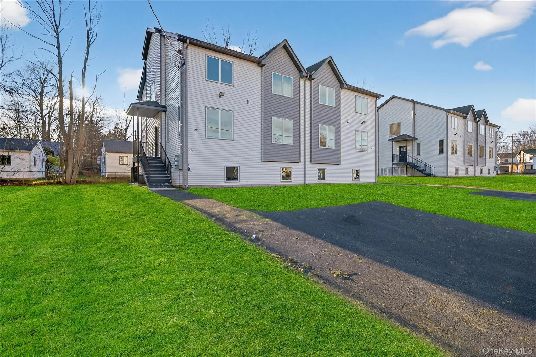 Back of property with a yard and a residential view Back of property with a yard and a residential view