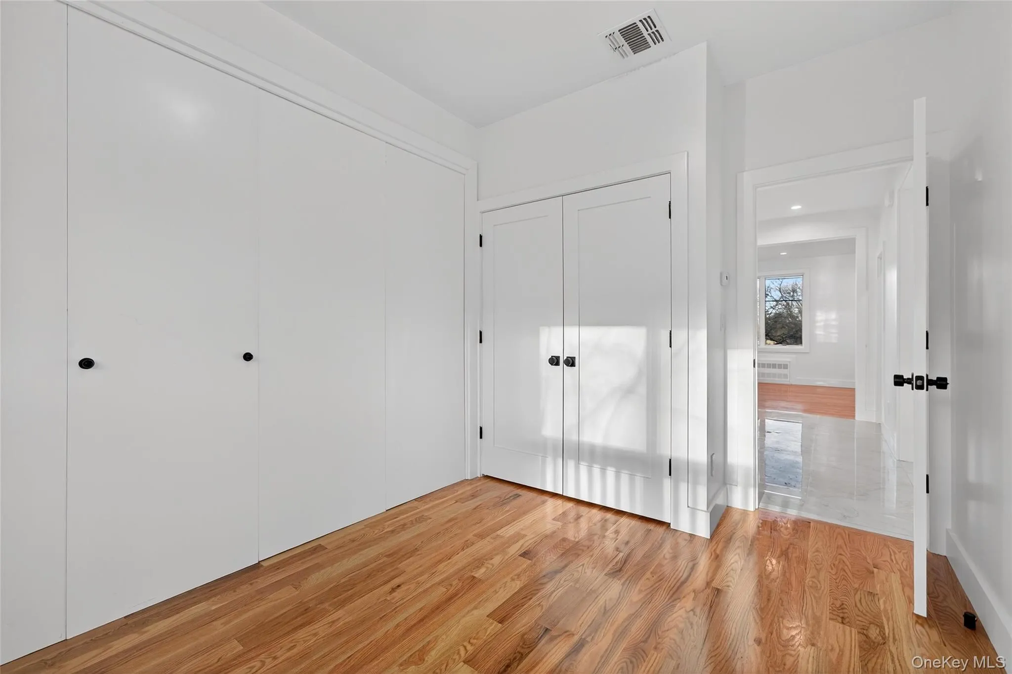 Unfurnished bedroom featuring a closet and light wood-type flooring Unfurnished bedroom featuring a closet and light wood-type flooring