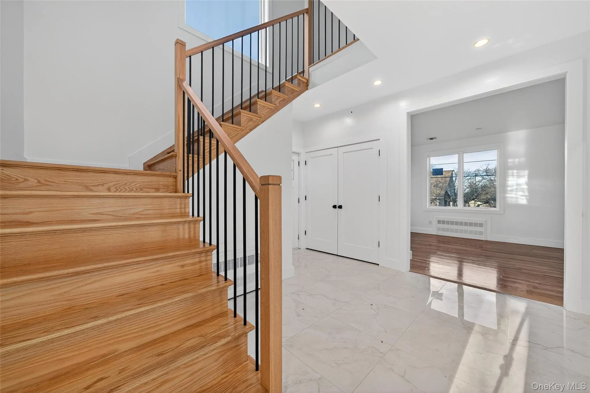 Staircase featuring marble look tile flooring and recessed lighting Staircase featuring marble look tile flooring and recessed lighting