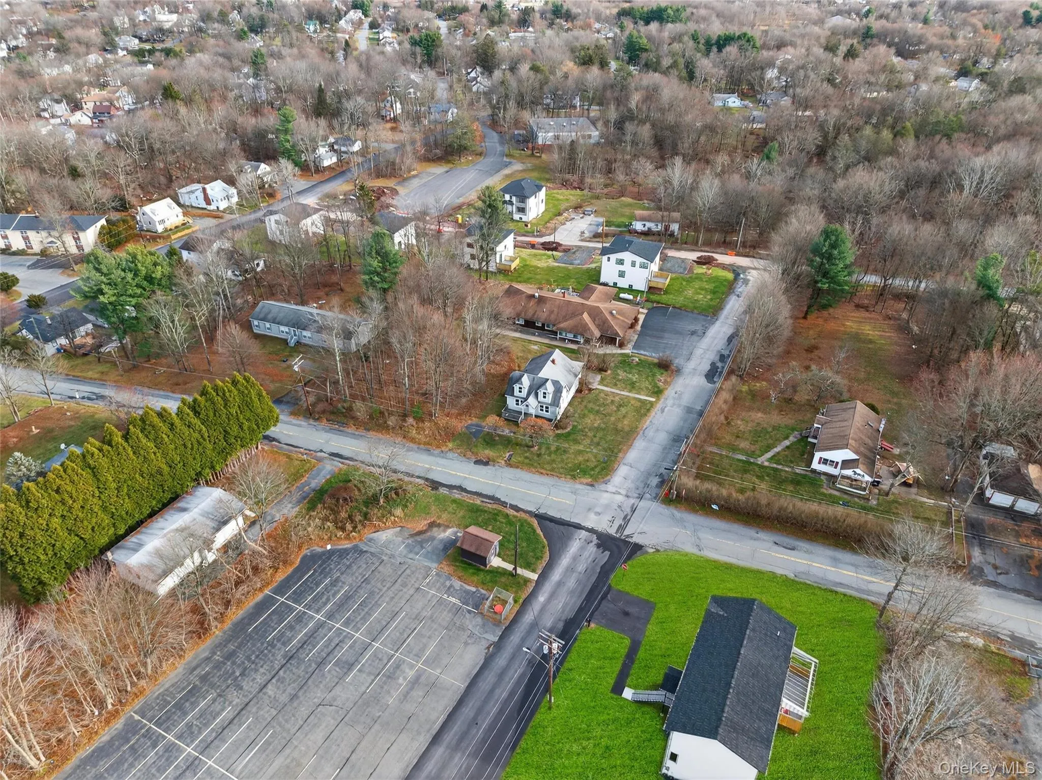 Aerial view of property and surrounding area with nearby suburban area Aerial view of property and surrounding area with nearby suburban area