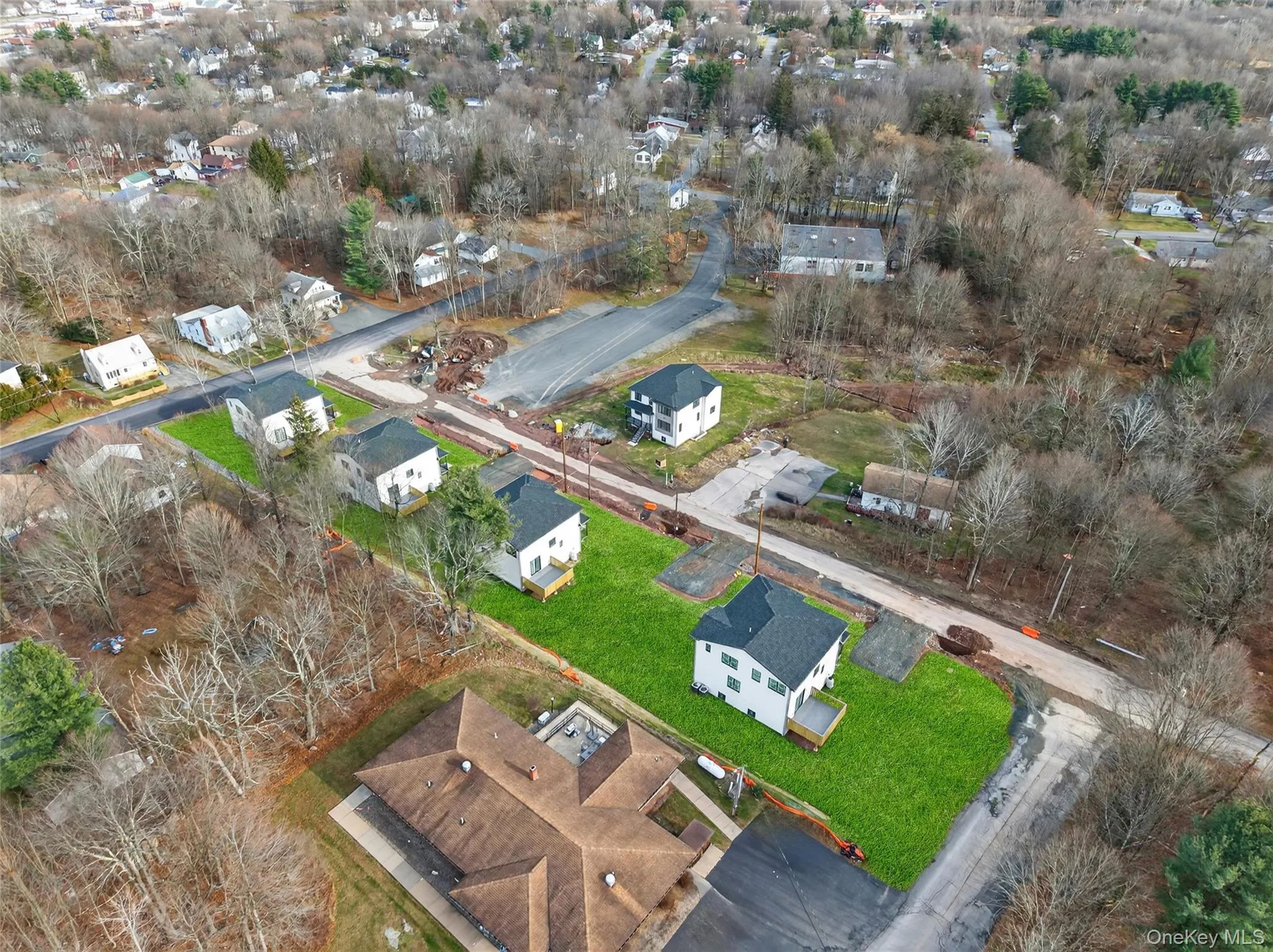 Aerial view of property and surrounding area featuring nearby suburban area Aerial view of property and surrounding area featuring nearby suburban area