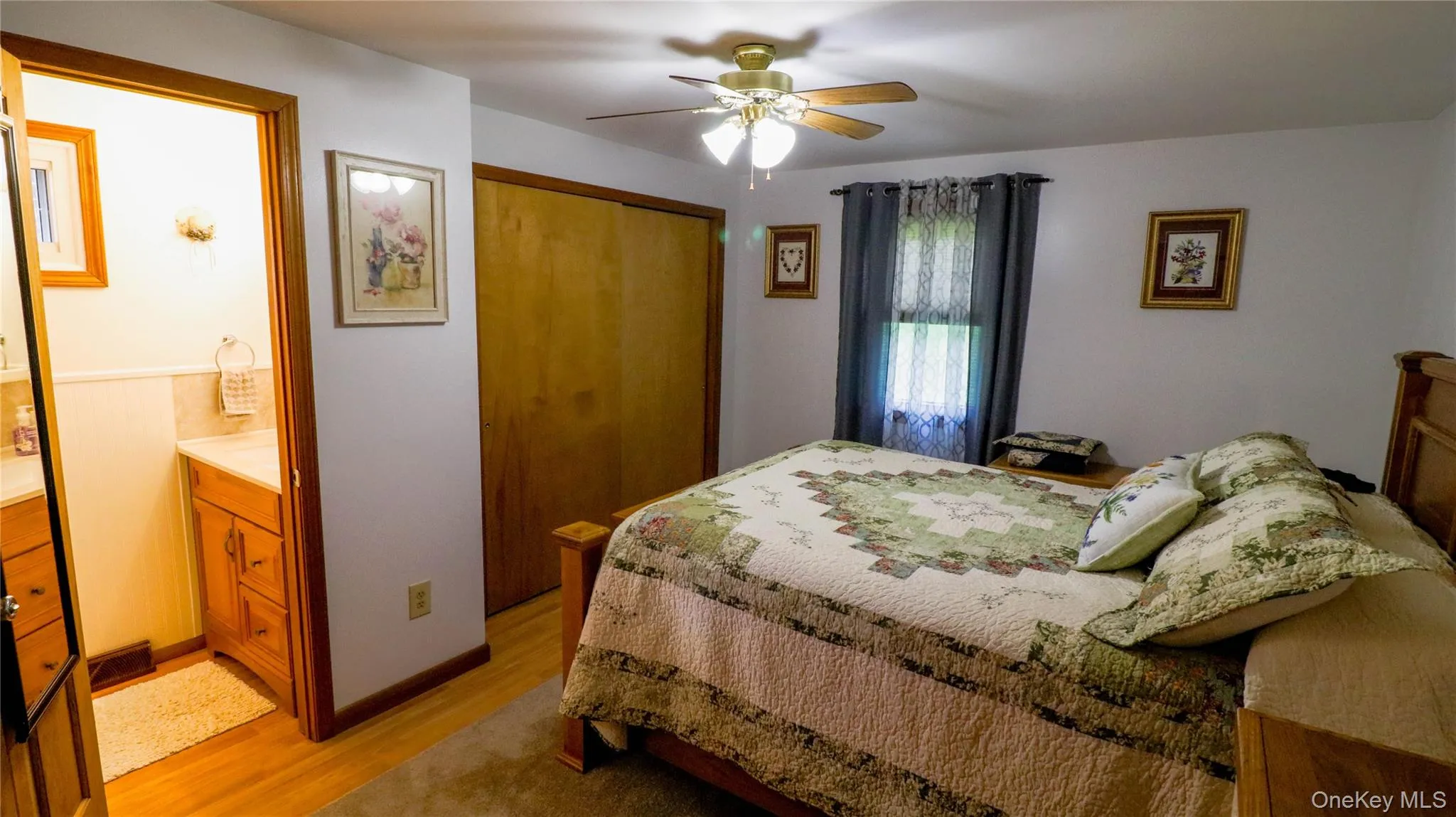 Bedroom featuring hardwood flooring, a ceiling fan, and a window with natural light Bedroom featuring hardwood flooring, a ceiling fan, and a window with natural light