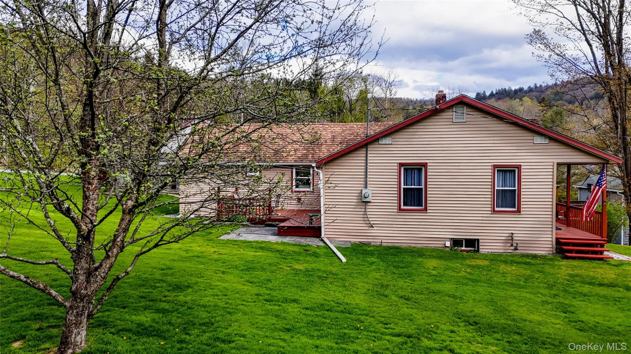 Cream-colored siding exterior with a red trim roofline Cream-colored siding exterior with a red trim roofline