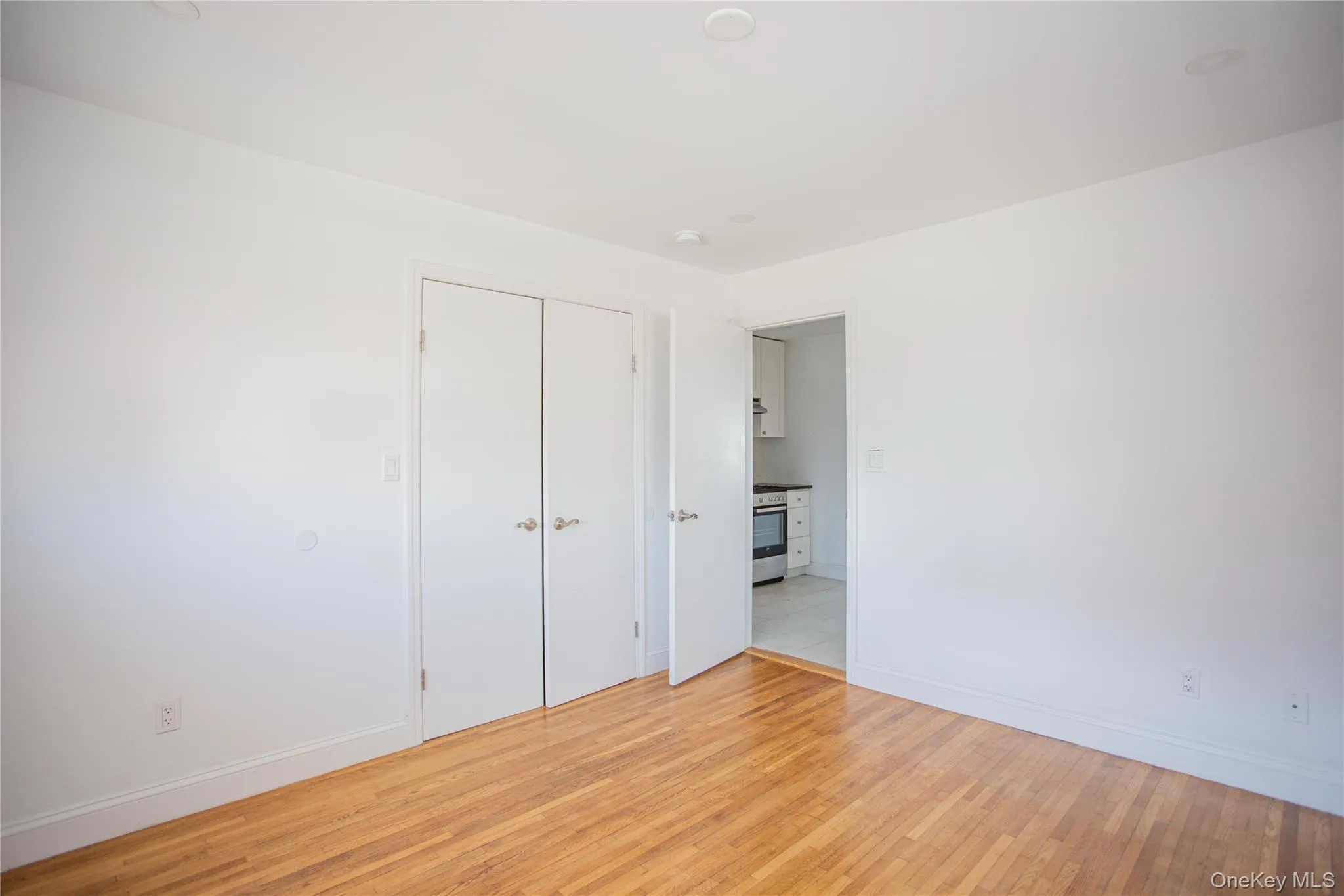 Unfurnished bedroom featuring light wood-style flooring and a closet Unfurnished bedroom featuring light wood-style flooring and a closet