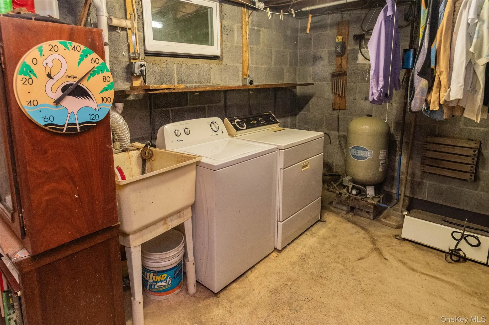 Dedicated laundry area featuring a utility sink, washer, and dryer Dedicated laundry area featuring a utility sink, washer, and dryer