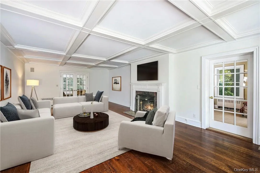 Digitally staged, the elegant formal living room, has coffered ceilings, a wood-burning fireplace and French doors to the family room and study. Digitally staged, the elegant formal living room, has coffered ceilings, a wood-burning fireplace and French doors to the family room and study.