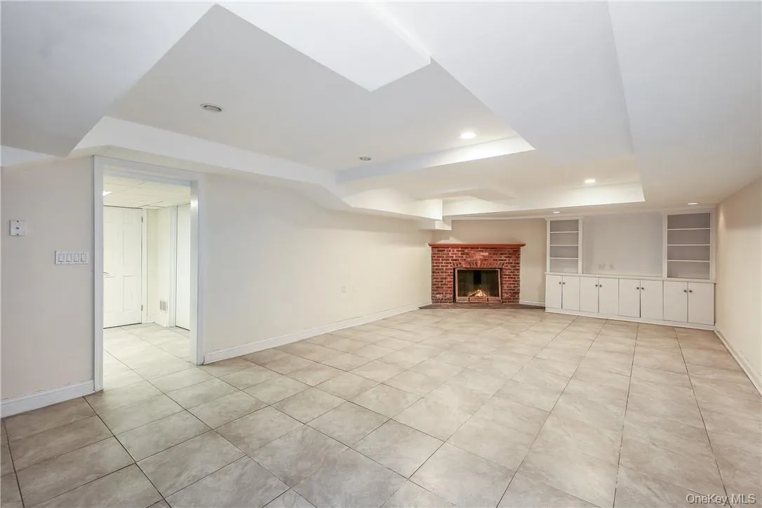 Lower level recreation space with fireplace and built-in cabinetry. There is also laundry, storage and mechanicals on this level. Lower level recreation space with fireplace and built-in cabinetry. There is also laundry, storage and mechanicals on this level.