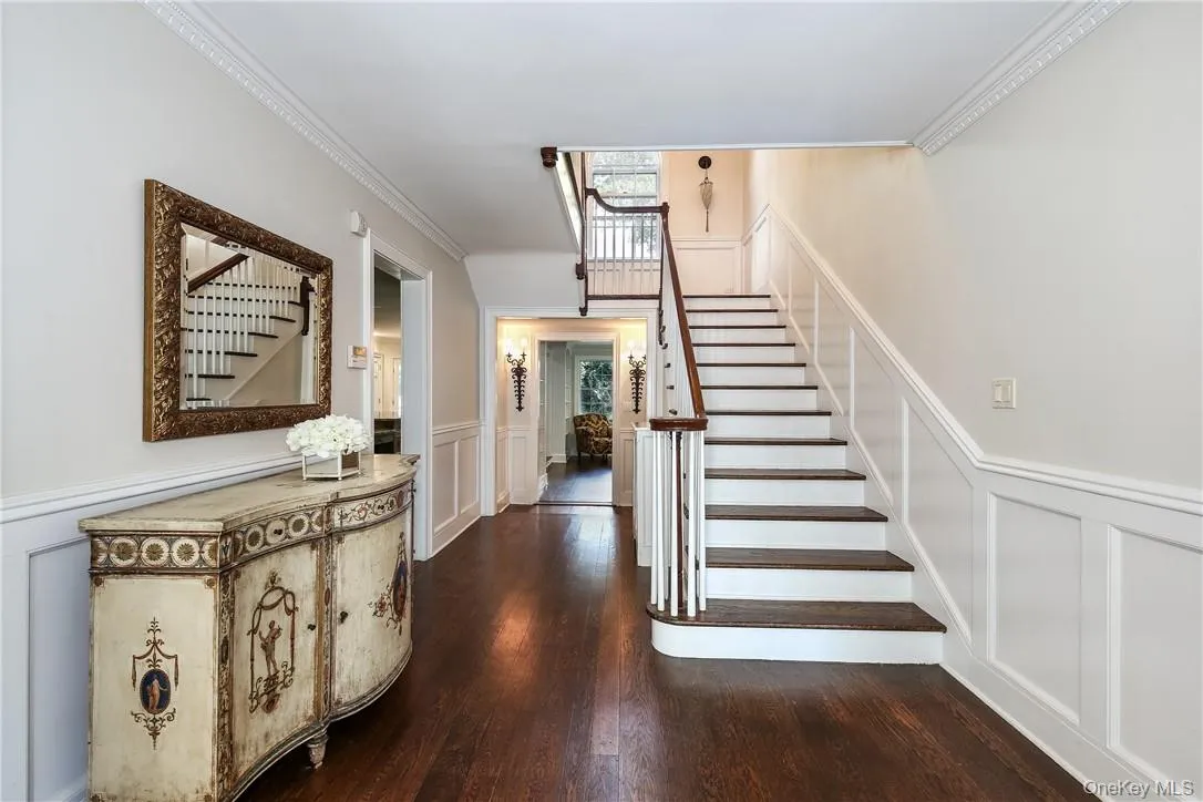 Entry hall with recently refinished hardwood floors and custom millwork. Entry hall with recently refinished hardwood floors and custom millwork.