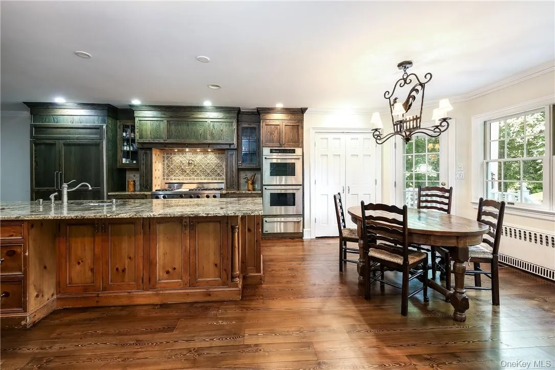 Kitchen features a large island, plenty of prep and storage space and a sunny breakfast spot. Kitchen features a large island, plenty of prep and storage space and a sunny breakfast spot.