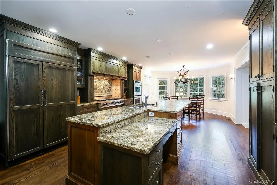 Another view of this beautiful kitchen with a large island. This side includes a desk area. Another view of this beautiful kitchen with a large island. This side includes a desk area.