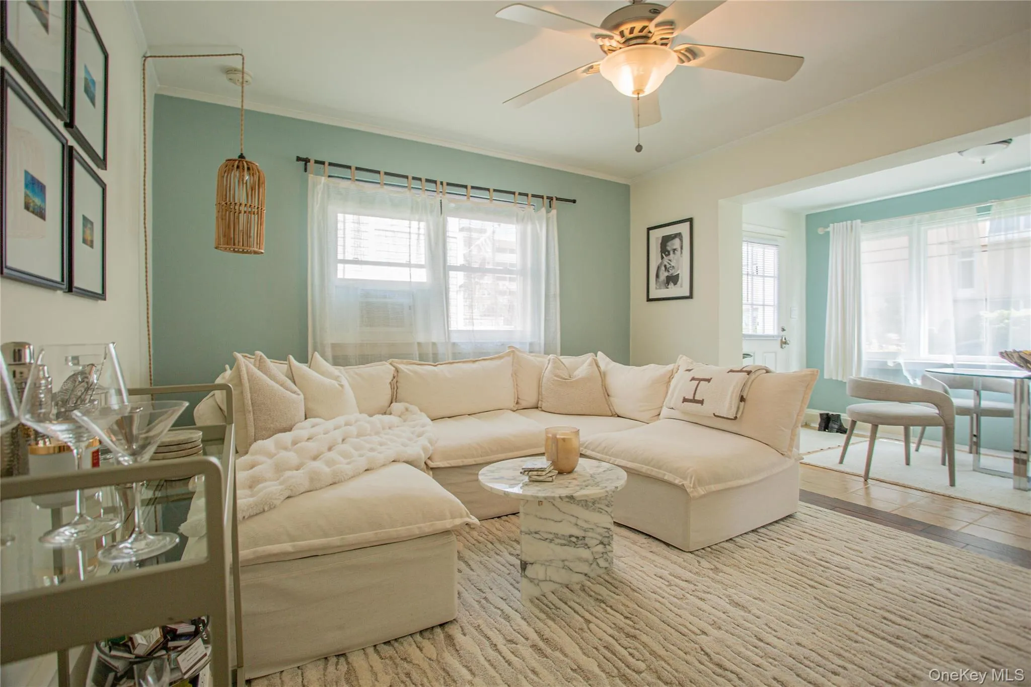 Living area featuring crown molding, a ceiling fan, and wood finished floors Living area featuring crown molding, a ceiling fan, and wood finished floors
