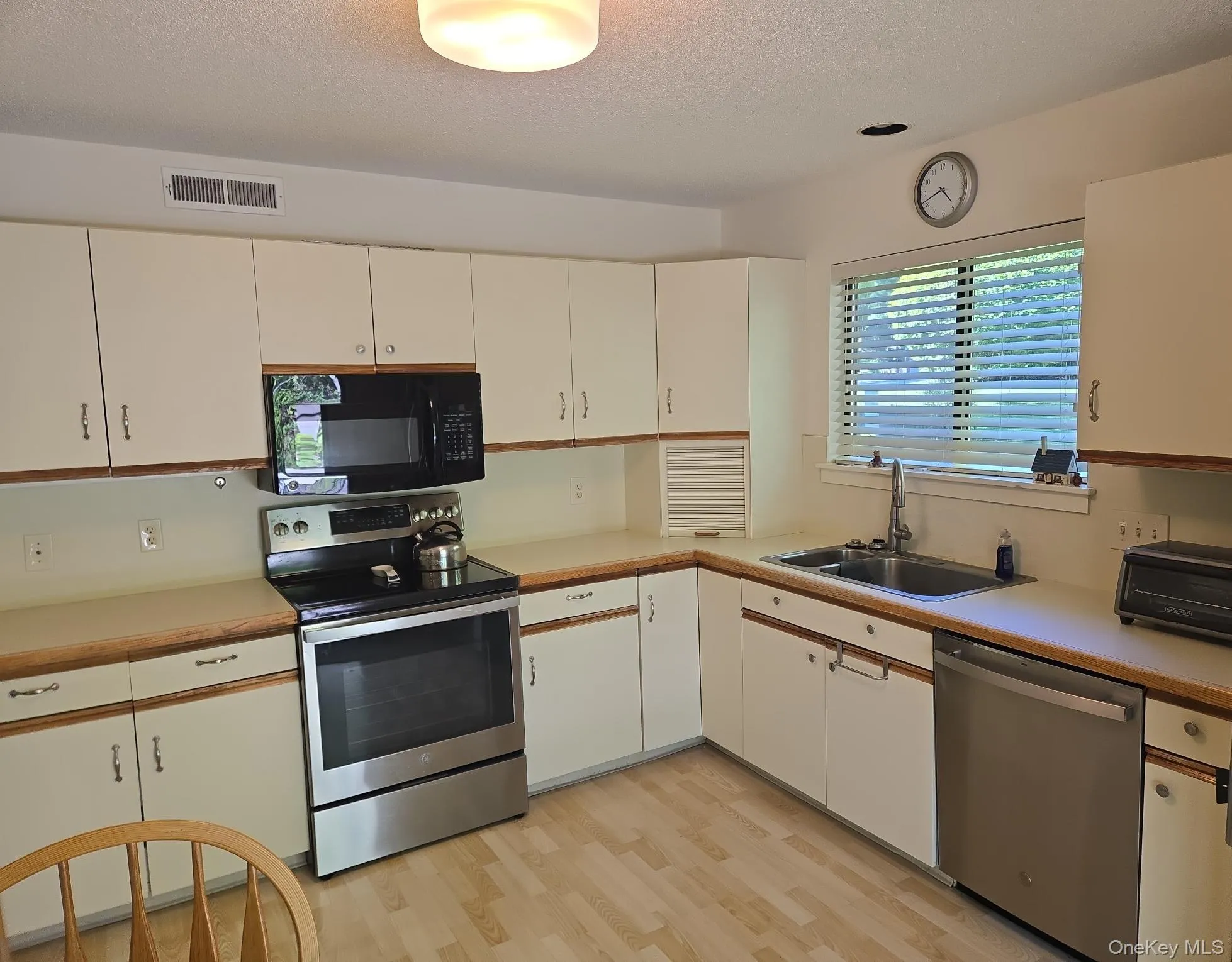 A large eat-in kitchen has ample cabinets and stainless steel appliances. A large eat-in kitchen has ample cabinets and stainless steel appliances.