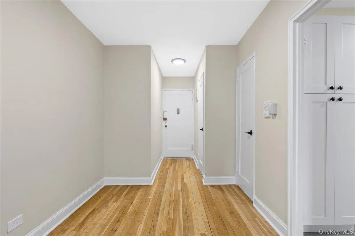 Dining area featuring wood-finish flooring, light-toned walls, and white baseboards Dining area featuring wood-finish flooring, light-toned walls, and white baseboards