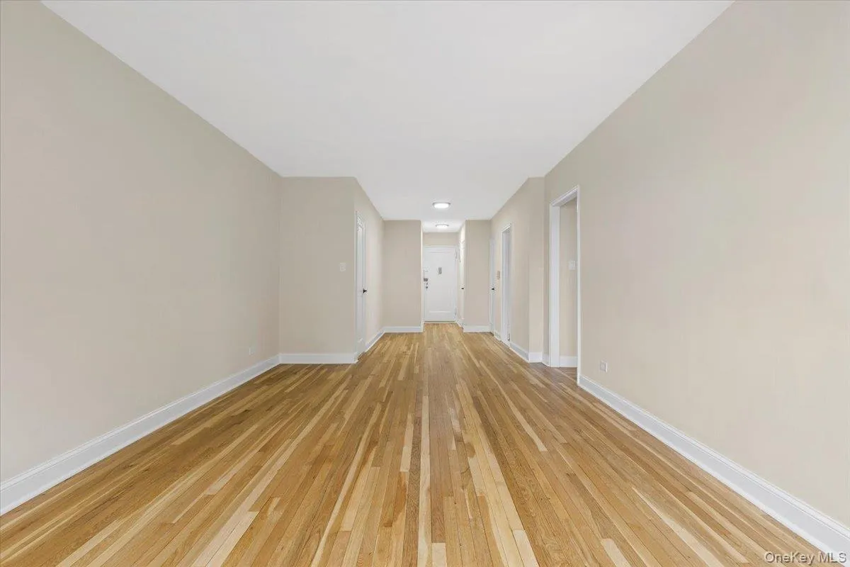 Open living area featuring hardwood flooring, light neutral wall paint, and recessed lighting Open living area featuring hardwood flooring, light neutral wall paint, and recessed lighting