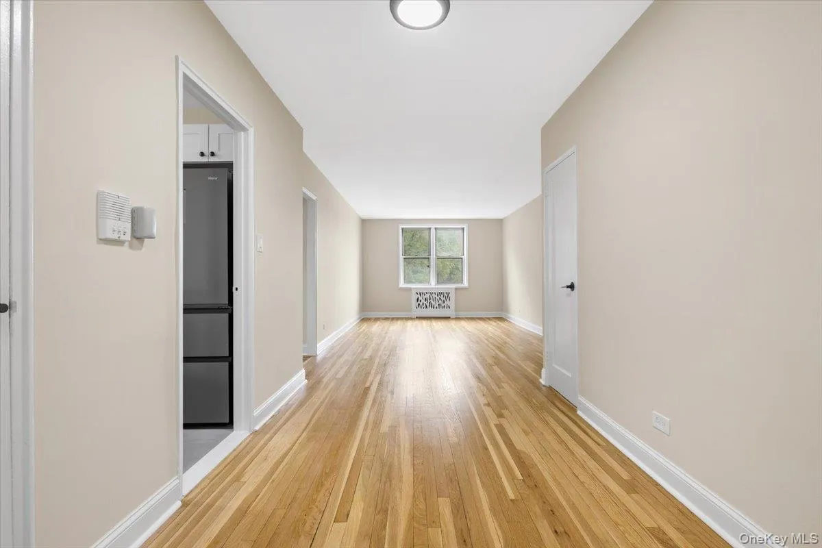 Dining area featuring wood-finish flooring, light-toned wall paint, and crisp white trim Dining area featuring wood-finish flooring, light-toned wall paint, and crisp white trim