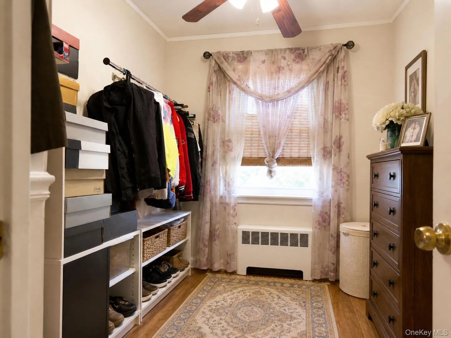 Room featuring wood-finish flooring and a ceiling fan Room featuring wood-finish flooring and a ceiling fan