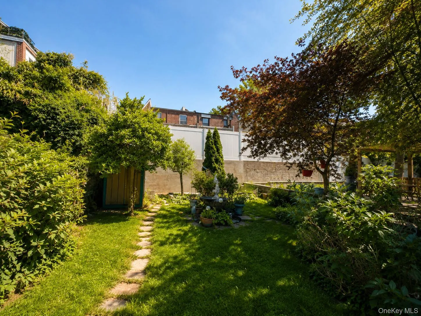 Expansive backyard featuring a manicured lawn, and mature trees Expansive backyard featuring a manicured lawn, and mature trees