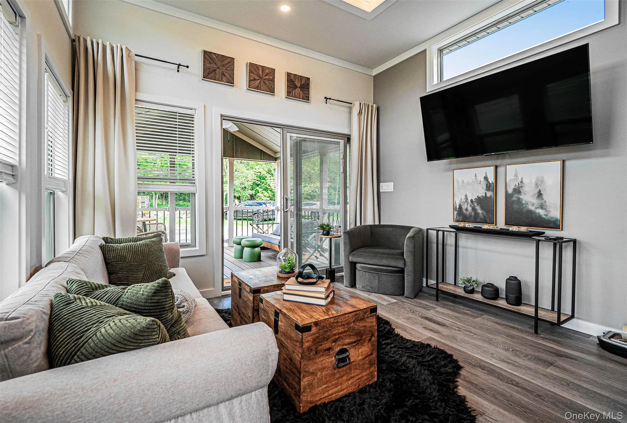 Living room featuring crown molding, wood-style floors, and recessed lighting Living room featuring crown molding, wood-style floors, and recessed lighting