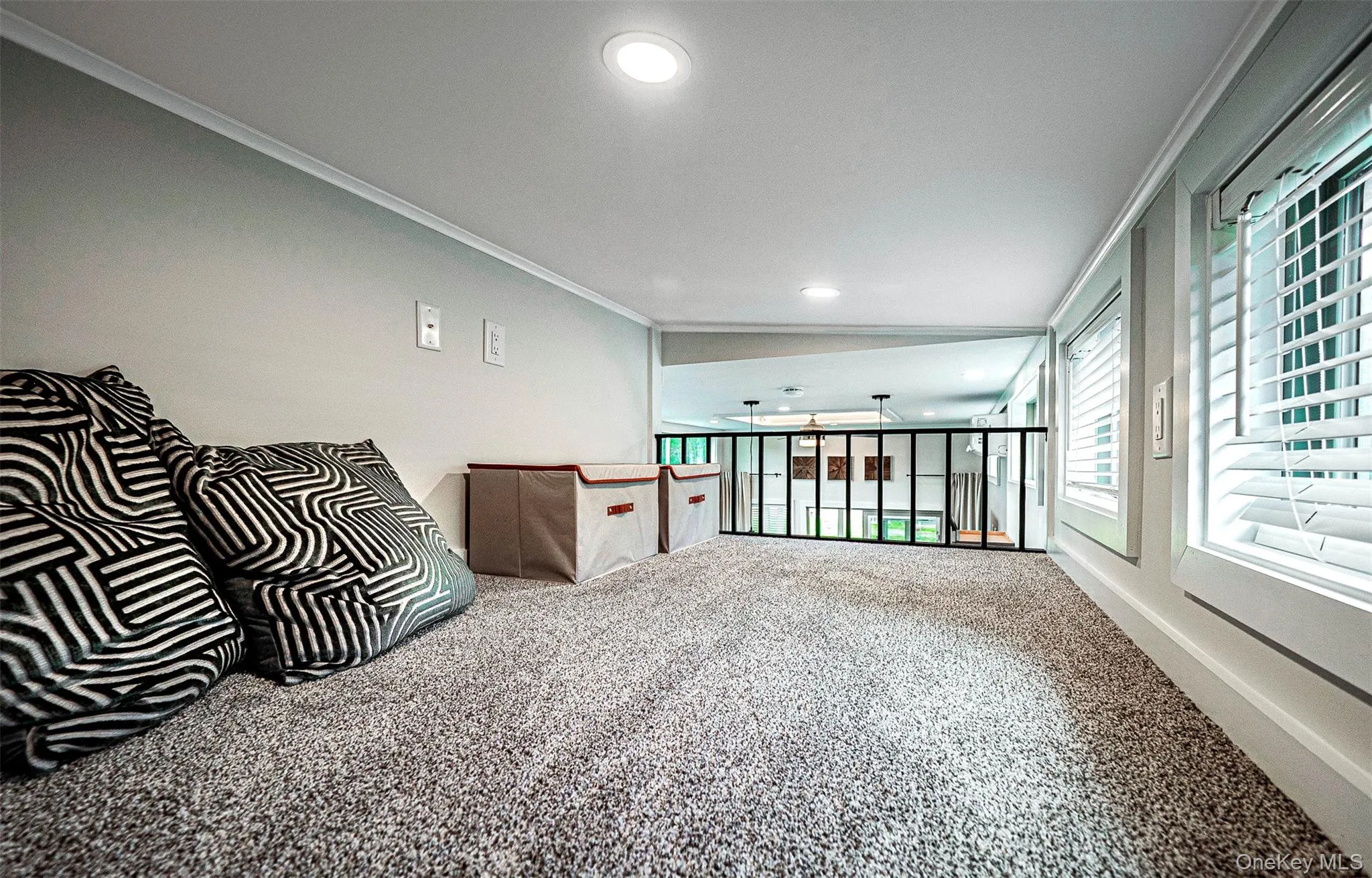Carpeted loft with ornamental molding, and recessed lighting Carpeted loft with ornamental molding, and recessed lighting