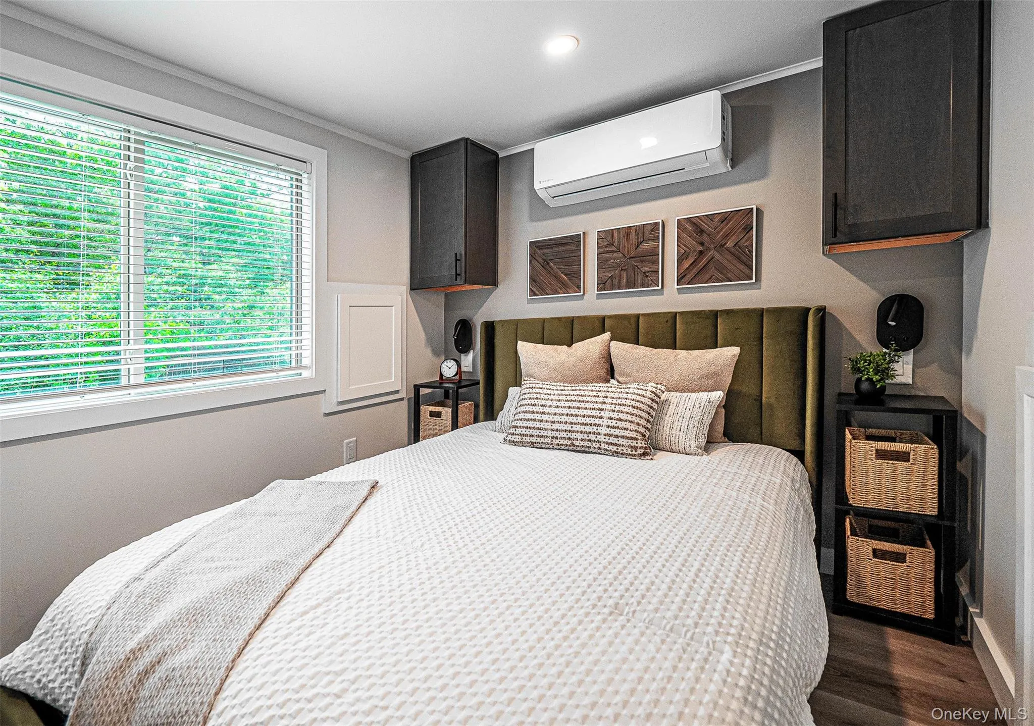 Bedroom with a wall mounted AC, dark wood-style floors, crown molding, and recessed lighting Bedroom with a wall mounted AC, dark wood-style floors, crown molding, and recessed lighting