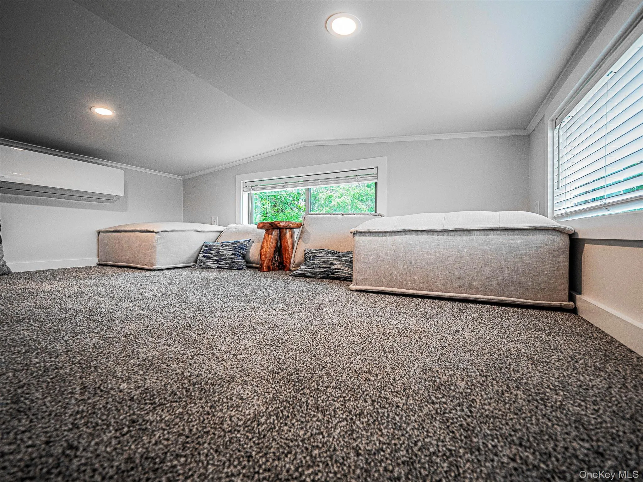 Carpeted loft featuring recessed lighting, and a wall mounted air conditioner Carpeted loft featuring recessed lighting, and a wall mounted air conditioner