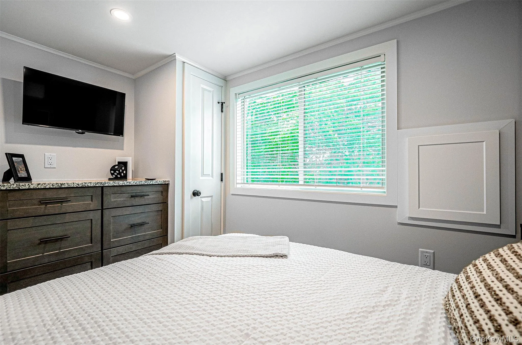 Bedroom featuring ornamental molding and recessed lighting Bedroom featuring ornamental molding and recessed lighting