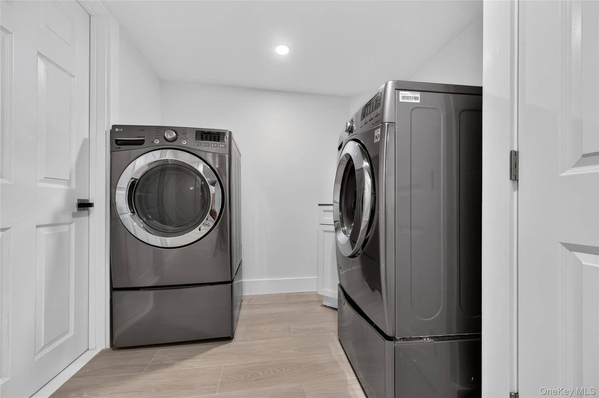 Dedicated laundry area featuring a front-loading washer and dryer set Dedicated laundry area featuring a front-loading washer and dryer set