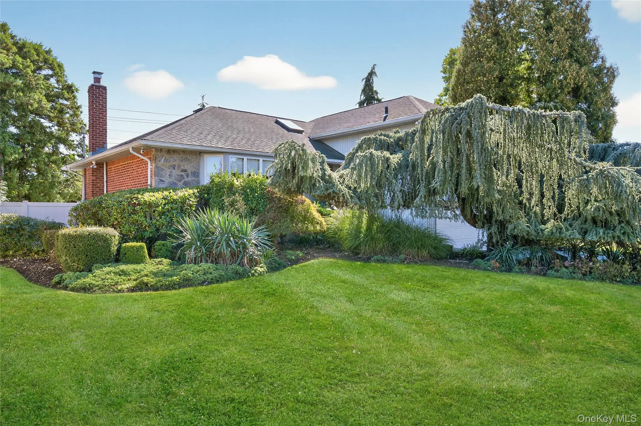 Front of home, showing beautiful mature trees and landscaping Front of home, showing beautiful mature trees and landscaping