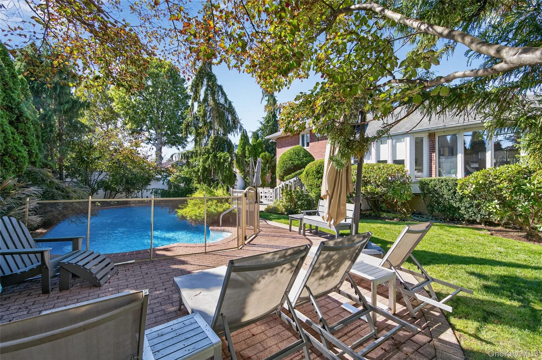 Backyard: In-ground heated saltwater swimming pool with patio area Backyard: In-ground heated saltwater swimming pool with patio area