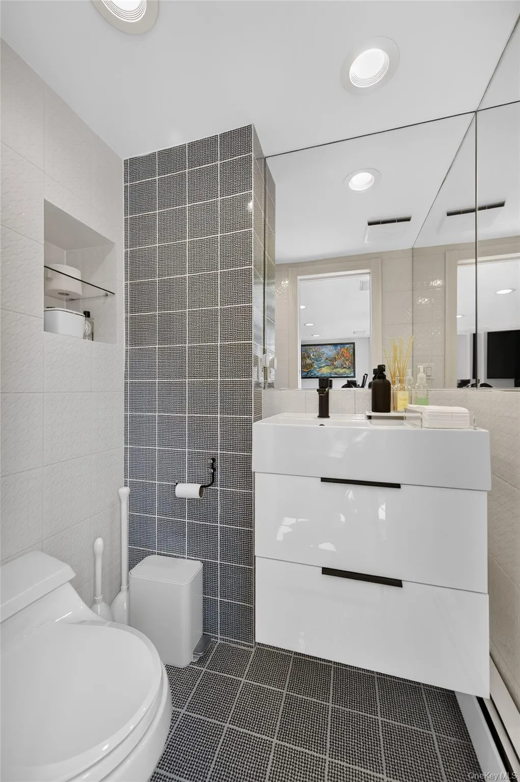 Modern bathroom featuring a floating vanity with integrated sink, recessed lighting Modern bathroom featuring a floating vanity with integrated sink, recessed lighting