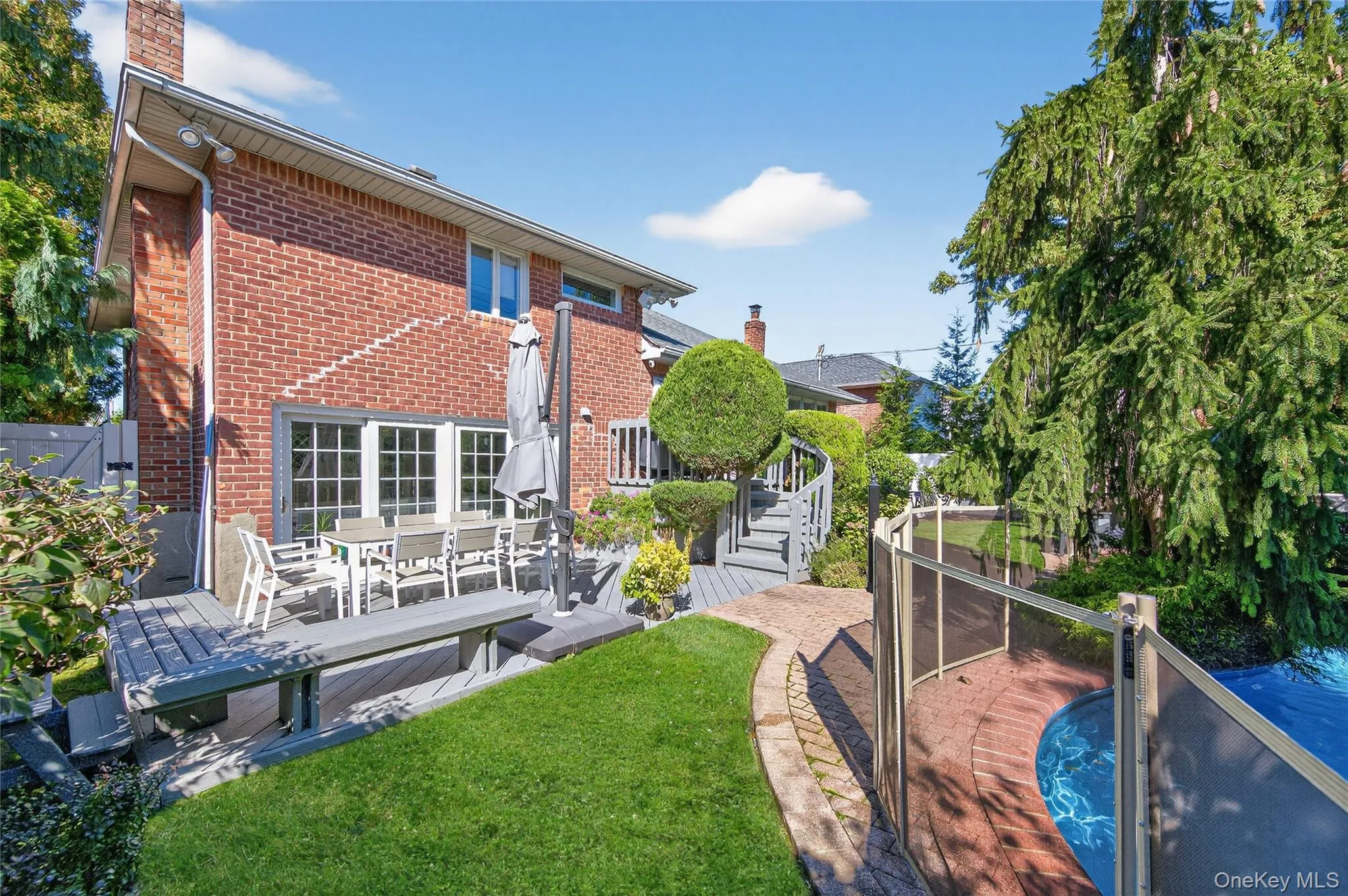 Backyard: In-ground heated saltwater swimming pool with patio and deck area Backyard: In-ground heated saltwater swimming pool with patio and deck area