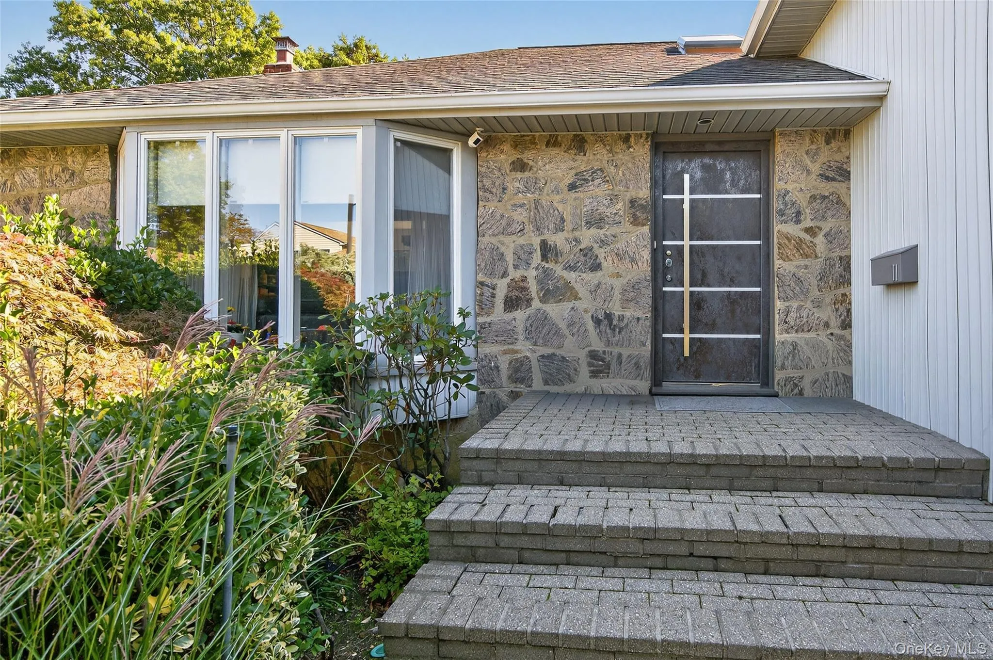 Stone facade with a custom European entry door Stone facade with a custom European entry door