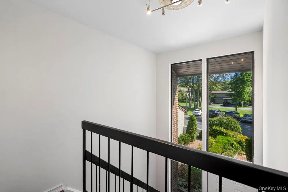 Modern staircase featuring black metal railings and white walls Modern staircase featuring black metal railings and white walls