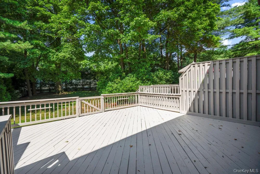 Spacious exterior deck featuring painted wood flooring and perimeter railing Spacious exterior deck featuring painted wood flooring and perimeter railing