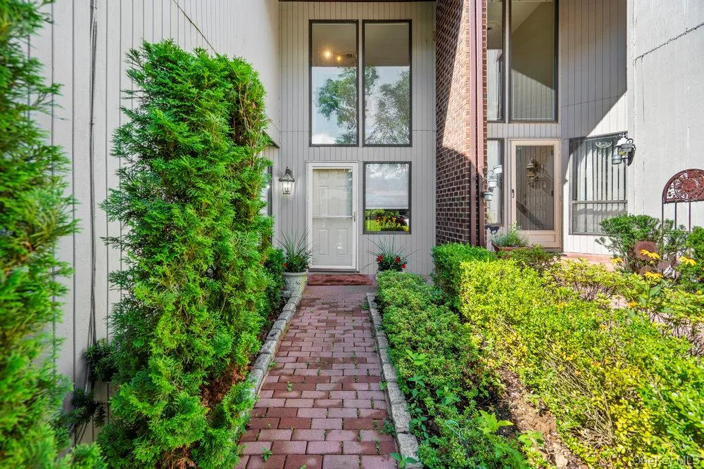 Contemporary architectural exterior featuring vertical siding and brick accents Contemporary architectural exterior featuring vertical siding and brick accents