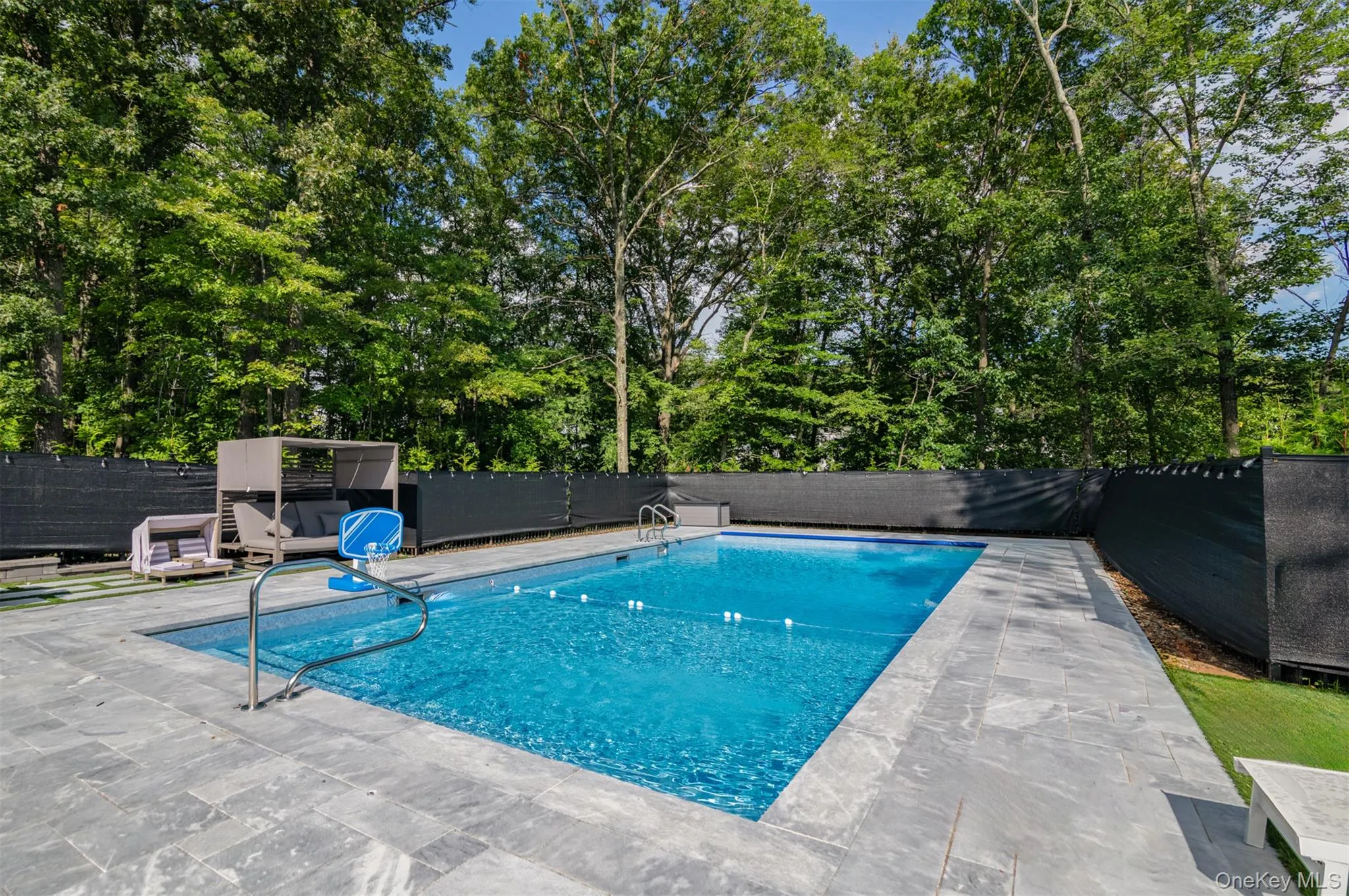 View of swimming pool with a fenced backyard View of swimming pool with a fenced backyard