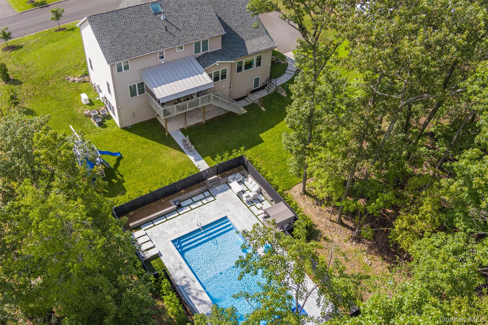 Aerial view of property and surrounding area with a pool area Aerial view of property and surrounding area with a pool area