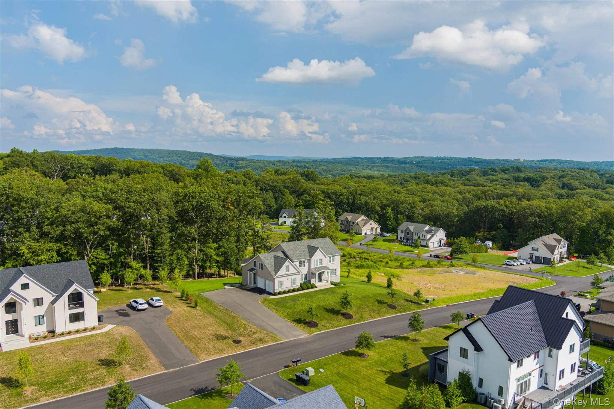 Aerial view of residential area featuring a heavily wooded area Aerial view of residential area featuring a heavily wooded area
