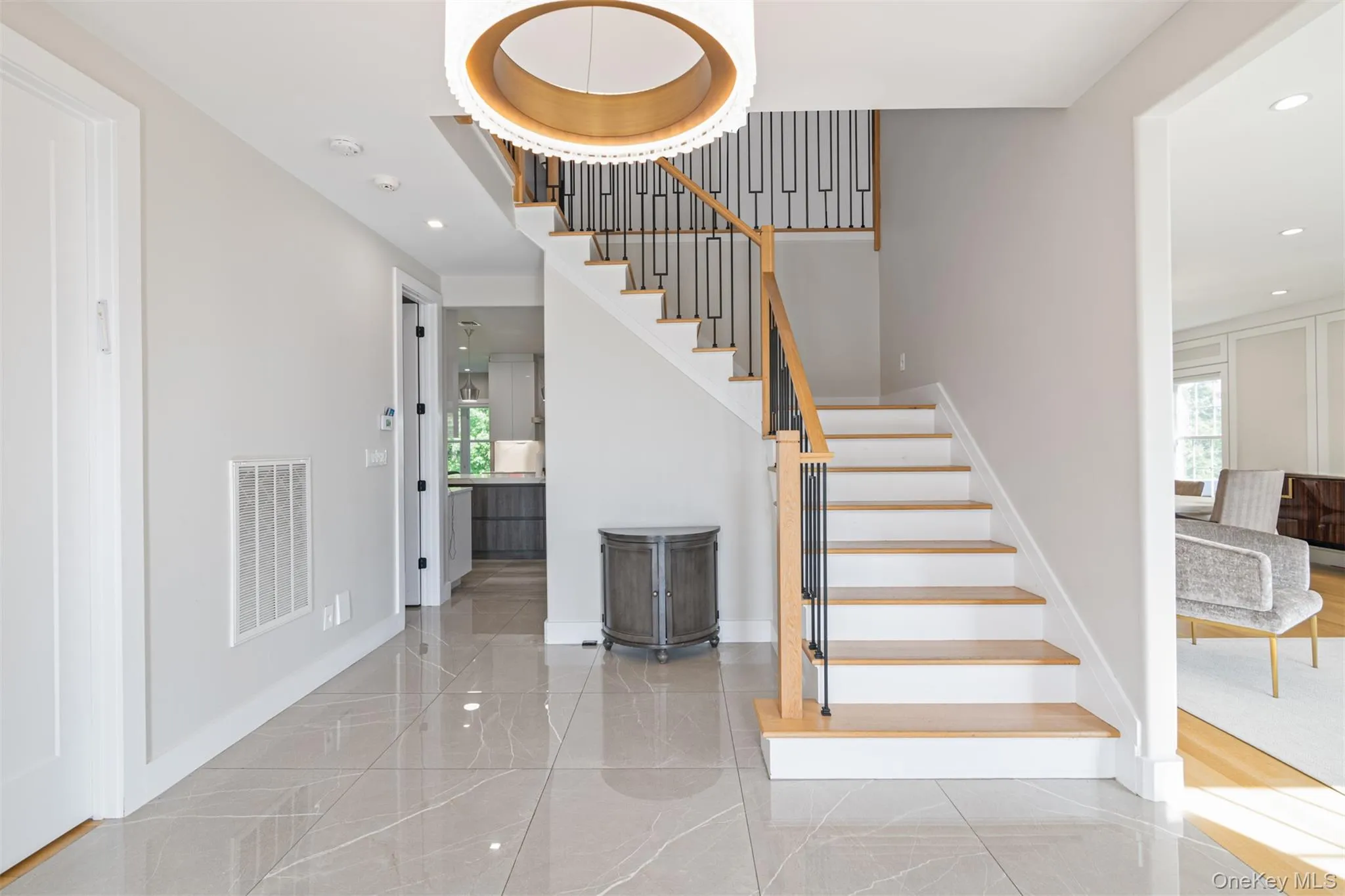 Staircase with recessed lighting and marble tiled flooring Staircase with recessed lighting and marble tiled flooring