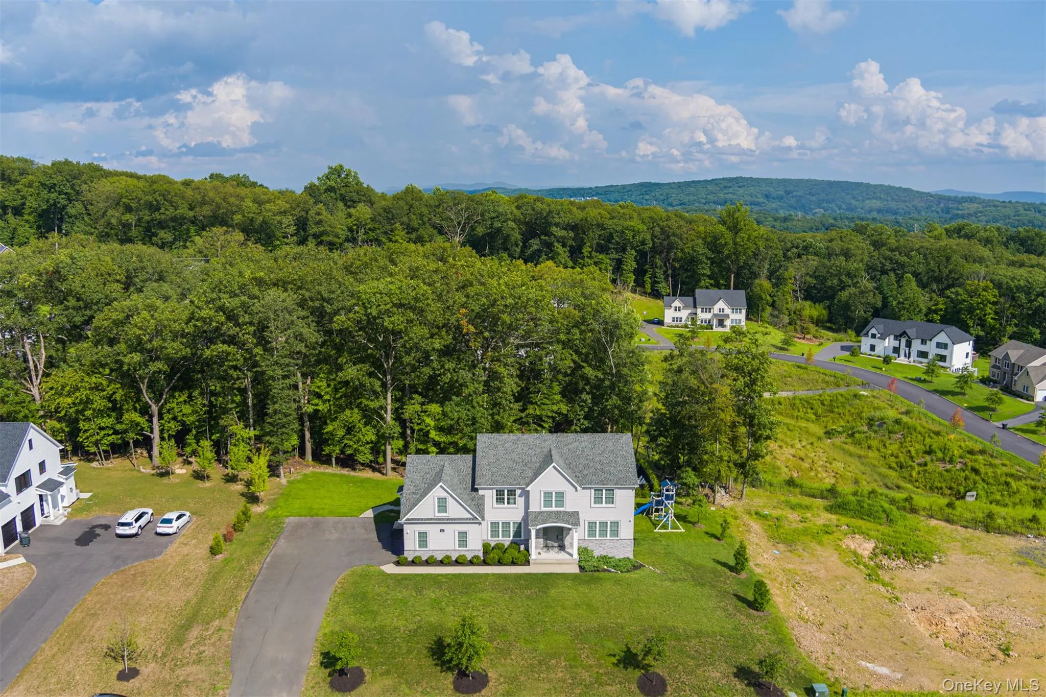 View from above of property featuring a heavily wooded area View from above of property featuring a heavily wooded area