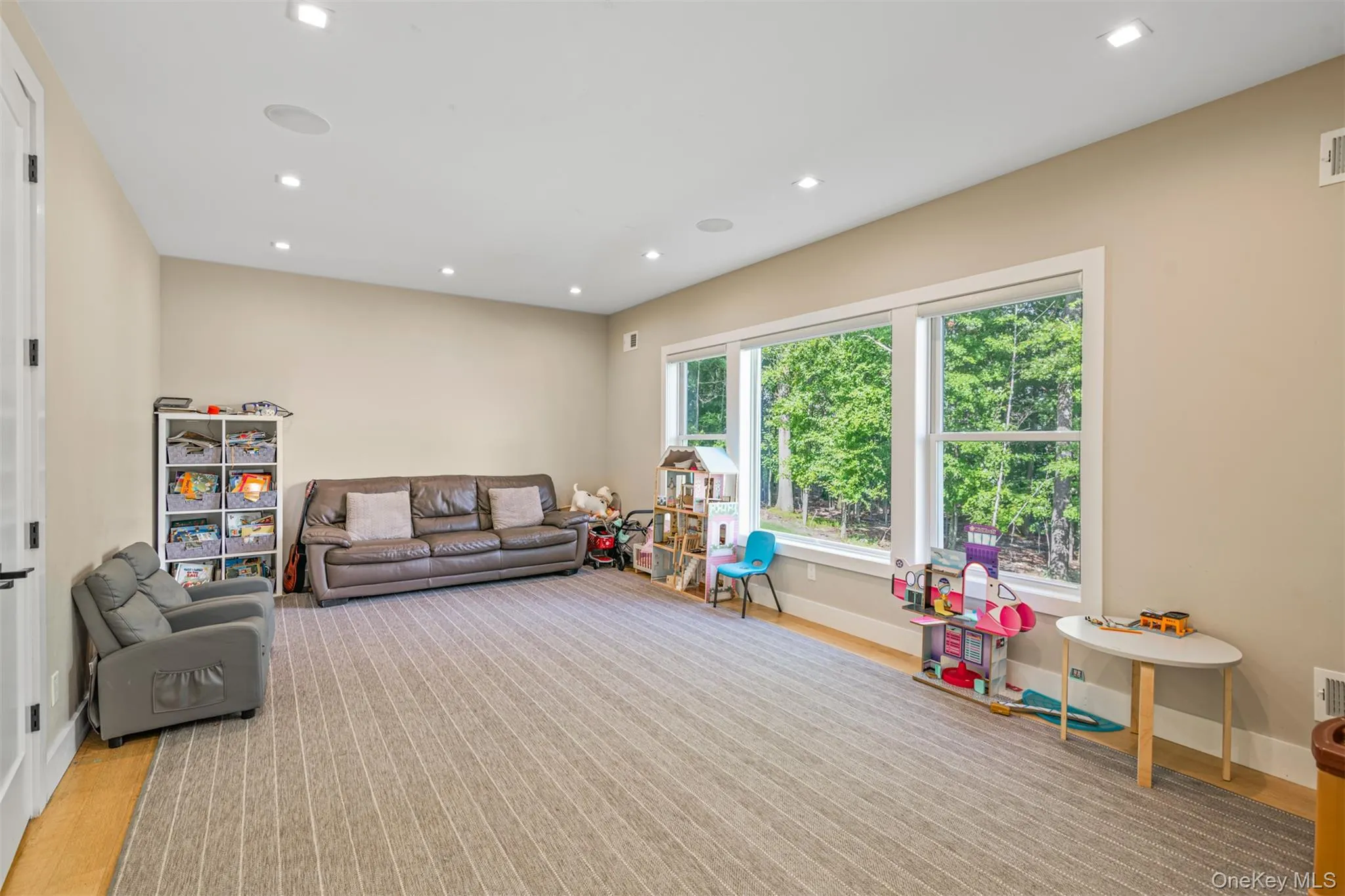 Living room with recessed lighting and light wood-style flooring Living room with recessed lighting and light wood-style flooring
