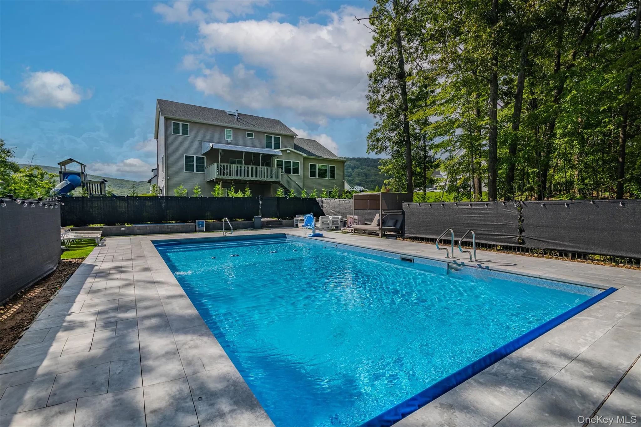 View of swimming pool with a patio area and a fenced backyard View of swimming pool with a patio area and a fenced backyard